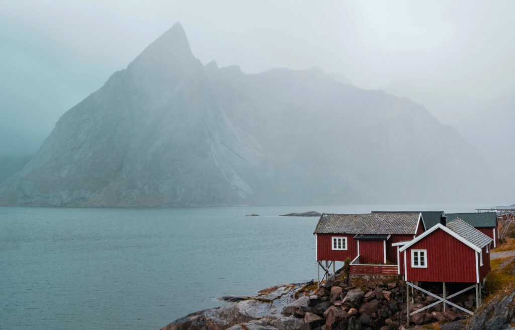 Fiskevær i nord-Norge. Fjell og hav i bakgrunnen.