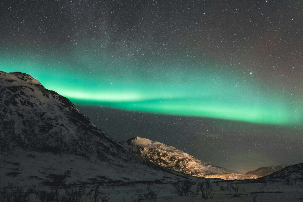 The image shows green northern lights on a dark night sky. It's a common phenomena in the north of Norway and arctic circle, where the hub for Visual Intelligence is based.