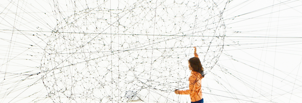 A girl explores an interactive art installation